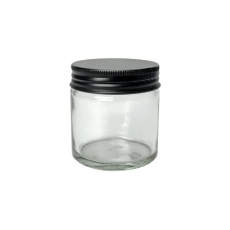 Klar glaskrukke 60 ml med sort aluminiumslåg – set forfra på neutral baggrund